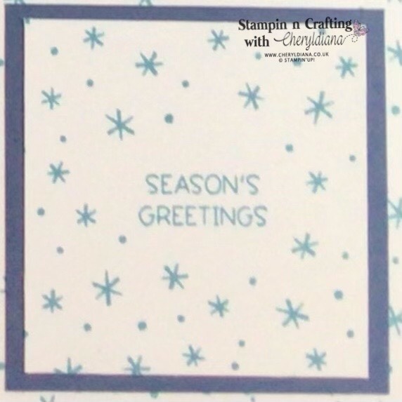 Photograph of stamped Seasons Greetings sentiment and snow flakes from the Penguin Place Sale-a-Bration Sampler