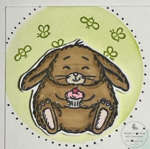 Photograph showing how I coloured in the rabbit image for my card that I made using a stencil made from an acetate sheet.