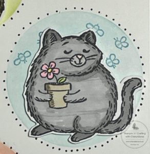 Photograph showing how I coloured in the cat image for my card that I made using a stencil made from an acetate sheet.