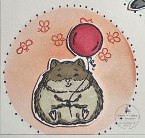 Photograph showing how I coloured in the hamster image for my card that I made using a stencil made from an acetate sheet.