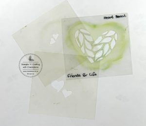 Photograph of the three hand made stencils for the scrapbook layout using handmade stencils for the background